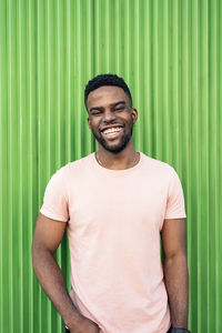 Portrait of smiling young man standing outdoors