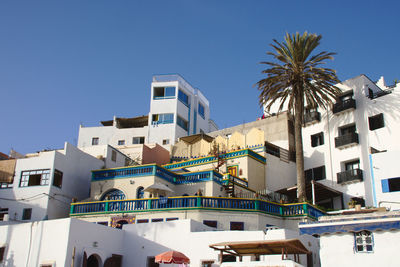 Low angle view of buildings against clear blue sky
