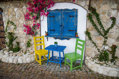 Empty chairs and tables in yard