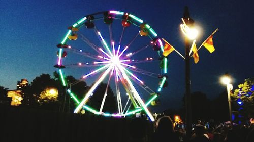 Low angle view of ferris wheel at night