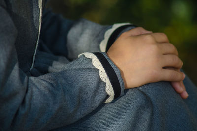 Midsection of man relaxing on hand