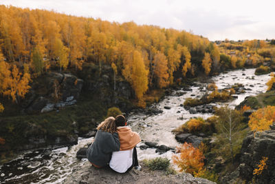 Happy people in love are travel hike in nature in the autumn forest. romantic trip to countryside