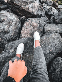 Low section of person standing on rock