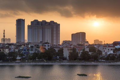 View of modern buildings against sky during sunset