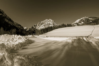 Scenic view of snowcapped mountains against clear sky