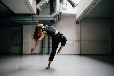 Young woman standing in corridor