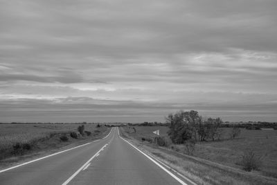 Road by landscape against sky