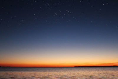 Scenic view of sea against clear sky at night