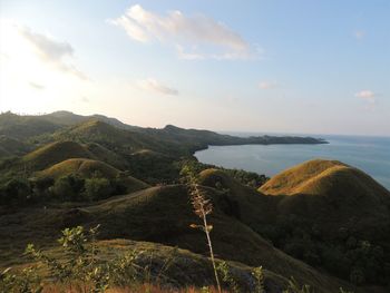 Scenic view of sea and mountains against sky