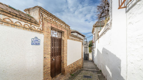 Alley amidst buildings against sky