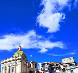 Low angle view of buildings against blue sky