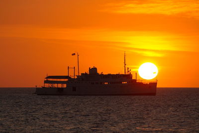 Scenic view of sea against orange sky during sunset