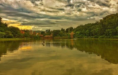 Scenic view of lake against cloudy sky