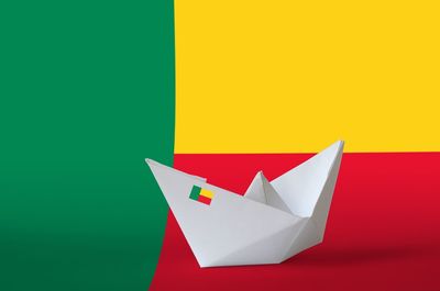 Close-up of paper flag against colored background