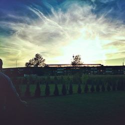 Scenic view of field against sky at sunset