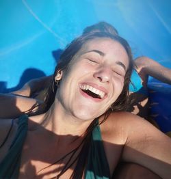 Portrait of young woman swimming in pool