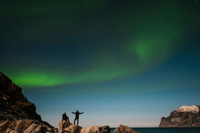 Low angle view of rock formation against sky at night