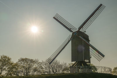 Low angle view of traditional windmill against sky