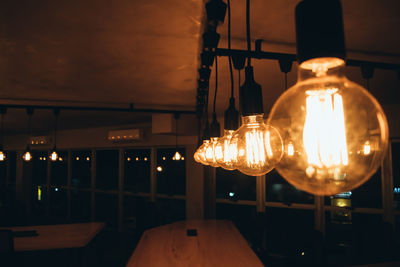 Illuminated light bulb at restaurant