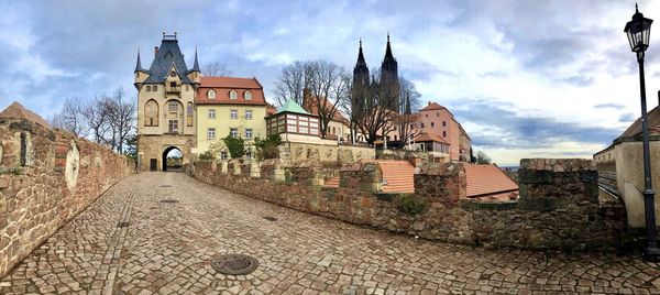 Panoramic view of buildings in city against sky