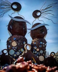 Low angle view of sculptures against sky