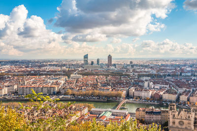 High angle view of city against cloudy sky