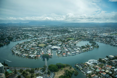 High angle view of townscape by sea against sky