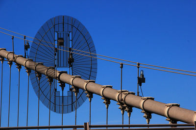 Low angle view of bridge against clear blue sky