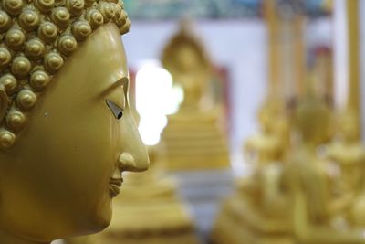 Close-up of buddha statue against building