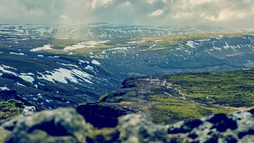 Aerial view of snowcapped mountains against sky