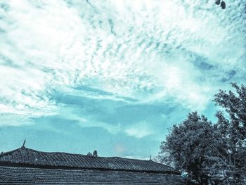 Low angle view of building against cloudy sky