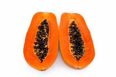 Close-up of orange slice over white background