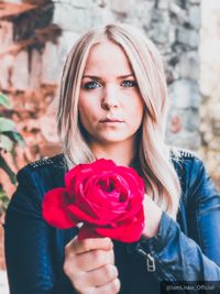 Portrait of beautiful woman with red rose