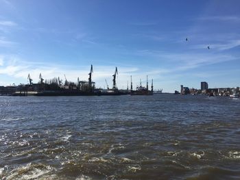 Commercial dock by sea against sky