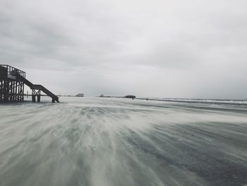 Scenic view of snow covered land against sky