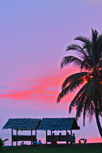 Scenic view of beach against clear sky at sunset