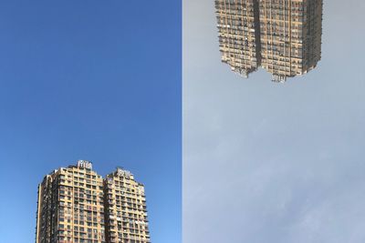 Low angle view of modern buildings against blue sky