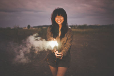 Portrait of young woman at sunset