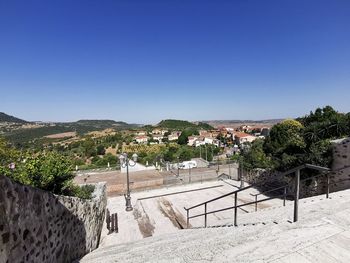 Scenic view of town against clear blue sky