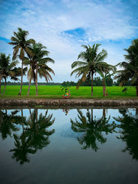 A kid driving bike on the bank of the river in kerala