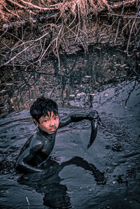 Portrait of boy in lake