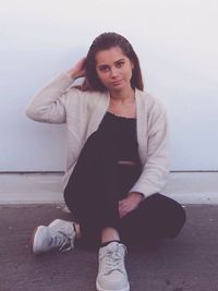 Portrait of young woman sitting outdoors