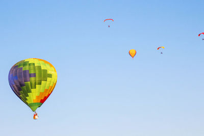 Low angle view of hot air balloons against clear sky