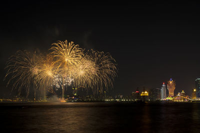 Firework display over city at night