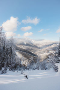 Scenic view of snowcapped mountains against sky