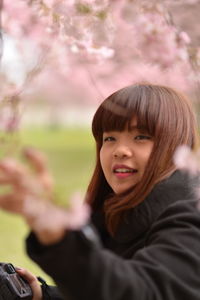 Smiling woman with bangs in public park