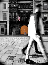 Blurred motion of people walking on street in city