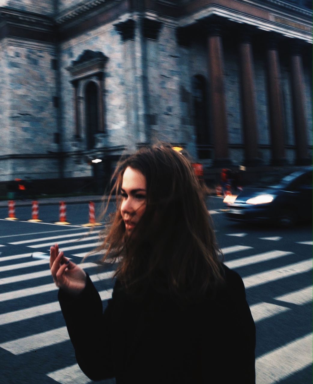 YOUNG WOMAN LOOKING AT ILLUMINATED CITY