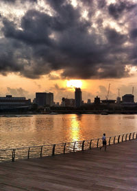 View of cityscape against cloudy sky