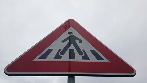 Close-up of arrow sign on road